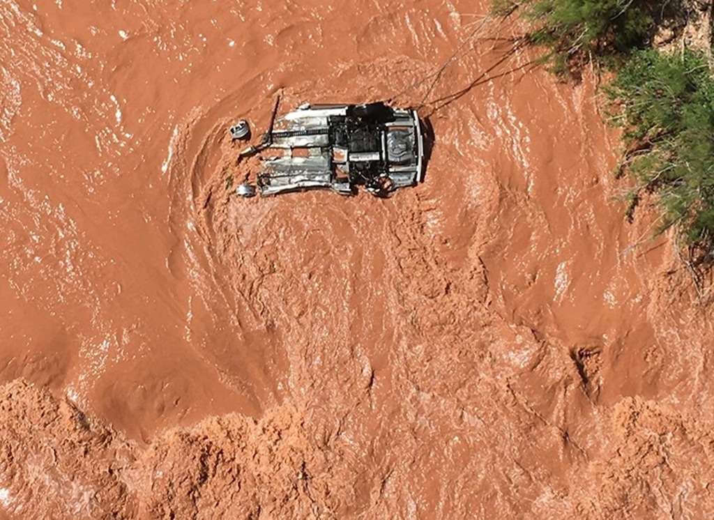 In this Friday, May 31, 2019 photo released by the Beaver Dam Littlefield Fire District shows an upside down vehicle in the Virgin River along Interstate 15 by bridge 7 near Littlefield, Ariz. Authorities say a Utah man sought in an alleged sex crime involving a juvenile is missing after his car went into a river in a northwestern Arizona gorge. Police in Hurricane, Utah, said in a statement that the man's car was spotted upside down after officers broke off a pursuit after the car entered Arizona. (Capt. Deborah Gates/Beaver Dam Littlefield Fire District Department via AP)