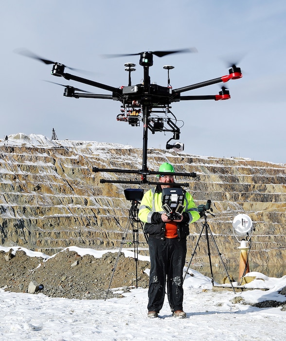 (Meagan Thompson/Montana Standard via AP) In this Nov. 9, 2018, photo, Ian Fairweather, of Montana Resources, operates a drone that is specially designed to haze waterfowl that land on the Berkeley Pit, a former open pit copper mine in Butte, Mont. Montana Resources uses boats, drones, rifles and sometimes fireworks to keep birds off of water in the pit, filled with water that is heavily acidic.