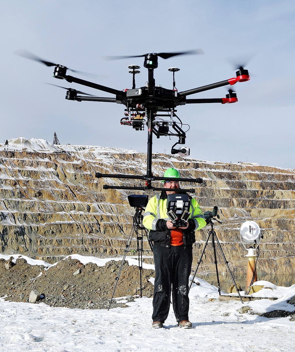 (Meagan Thompson/Montana Standard via AP) In this Nov. 9, 2018, photo, Ian Fairweather, of Montana Resources, operates a drone that is specially designed to haze waterfowl that land on the Berkeley Pit, a former open pit copper mine in Butte, Mont. Montana Resources uses boats, drones, rifles and sometimes fireworks to keep birds off of water in the pit, filled with water that is heavily acidic.