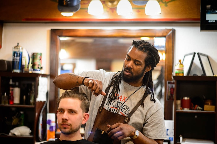 (Trent Nelson | The Salt Lake Tribune)
Charles Henderson styles Darren Kuefner's hair at Ray's Barber Shop in Salt Lake City on Thursday Feb. 28, 2019.