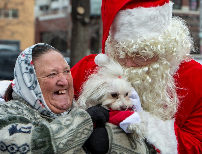 Dotty Antonio and her dog Carmela visit Santa Claus during the Street Dawg Crew Christmas outreach at Liberty Park Sunday.  The Street Dawg Crew supports the homeless and their pets every Sunday at Pioneer Park. Today besides passing out food and gift bags for humans and animals, they offered a photo opportunity with Santa. Sunday, Dec. 22, 2019.