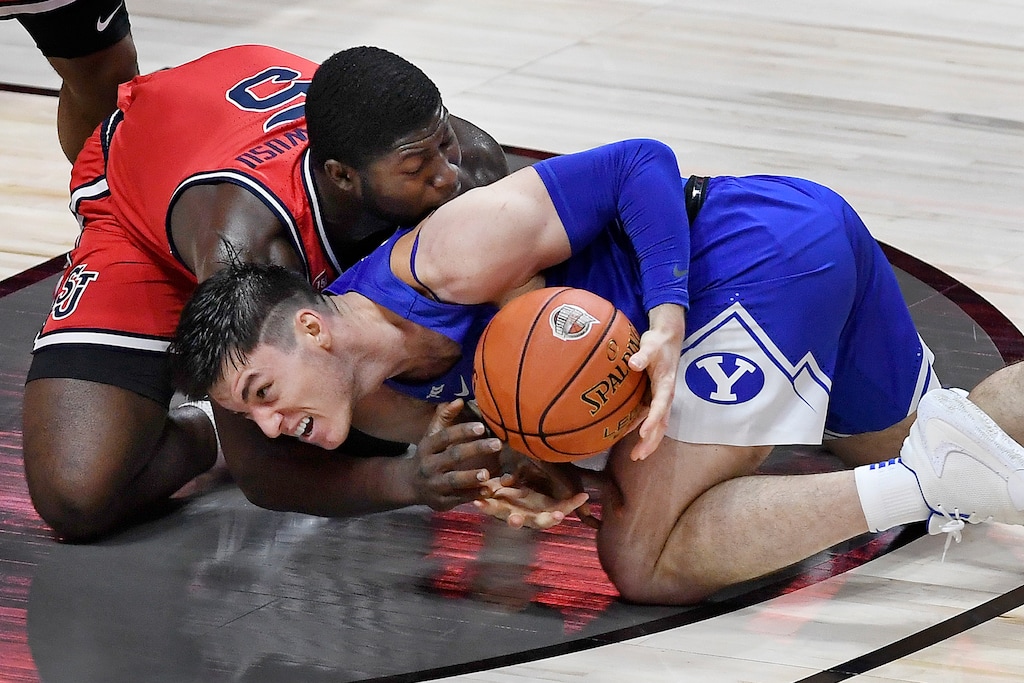 St. John's Dylan Addae-Wusu, left, and BYU's Alex Barcello fight for the ball in the second half of an NCAA college basketball game, Wednesday, Dec. 2, 2020, in Uncasville, Conn. (AP Photo/Jessica Hill)