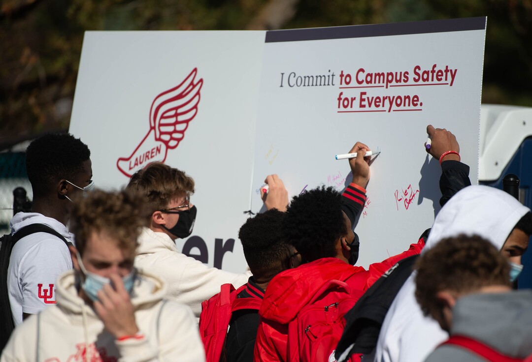 (Francisco Kjolseth  |  The Salt Lake Tribune) Members of the University of Utah basketball team sign their names in a pledge for campus safety as people gather for a memorial walk on the track where University of Utah student and track athlete Lauren McCluskey used to compete, for a remembrance on the two-year anniversary of her murder on Thursday, Oct. 22, 2020.