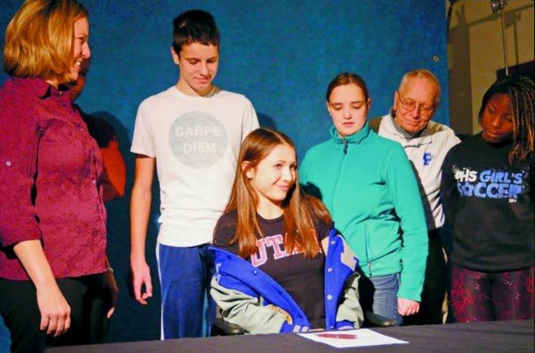 (Courtesy The Moscow-Pullman Daily News) This Nov. 20, 2014, file photo shows Lauren McCluskey as she removed her Pullman High School jacket to reveal a University of Utah T-shirt. McCluskey signed a letter of intent to compete in track for the University of Utah. 
