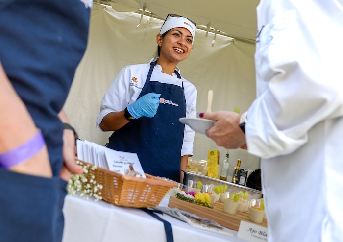 Leah Hogsten | The Salt Lake Tribune Desma Hengst, a student at Park City Culinary Institute, serves up Ajo Banco, a cold Spanish soup during the annual Taste of the Wasatch food and wine event Sunday, August 5, 2018 at Solitude.