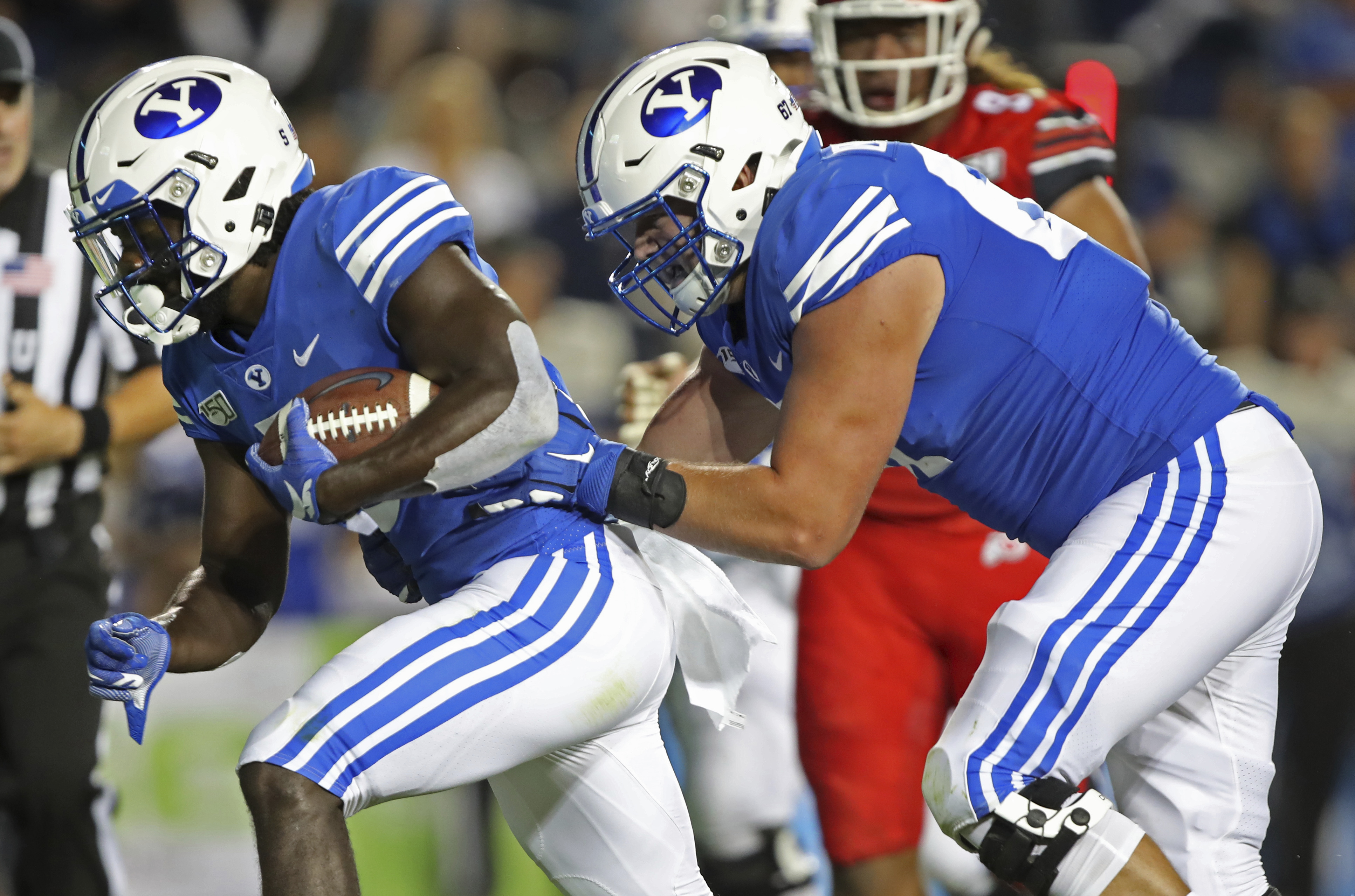 BYU offensive lineman Brady Christensen, right, pushes in running back Ty'Son Williams, left, for a touchdown in the second half during an NCAA college football game, Thursday, Aug. 29, 2019, in Provo, Utah. (AP Photo/George Frey)