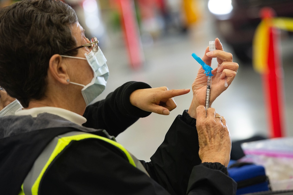 (Francisco Kjolseth | The Salt Lake Tribune) Registered nurse for Davis County Paula Johnson prepares the Pfizer vaccine as the Davis County School District begins COVID-19 vaccinations for its teachers at the Davis County Legacy Center in Farmington on Tuesday, Jan. 12, 2021.