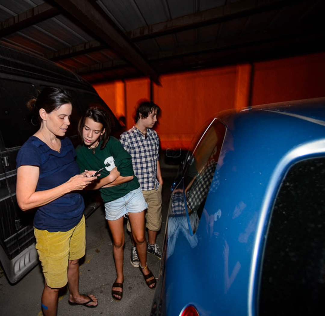 (Trent Nelson | The Salt Lake Tribune) Jenn, Ady, and Chase Hein find three scooters locked in a parked vehicle in Salt Lake City Tuesday Aug. 7, 2018. Hein works as a "Bird charger" on the side to make some extra cash, picking up and charging electric scooters overnight and returning them to the city streets in the early morning.