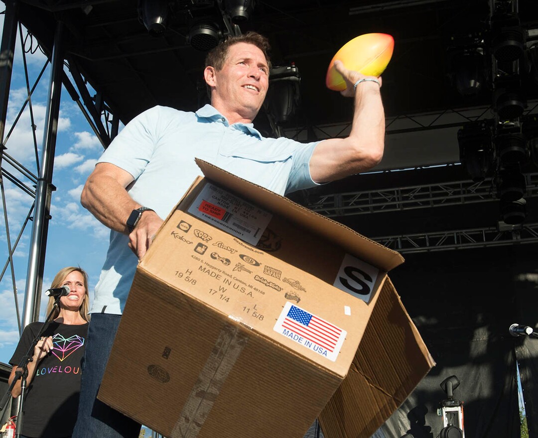 (Rick Egan  |  The Salt Lake Tribune)  Steve Young tosses footballs into the crowd at the LoveLoud Festival at Brent Brown Ballpark at UVU campus, Saturday, August 26, 2017.
