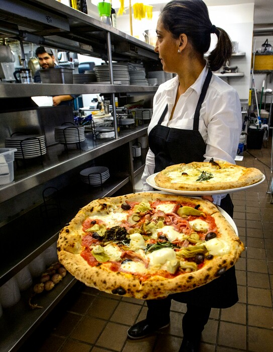 (Steve Griffin  |  The Salt Lake Tribune)   Florita Anastasi with pizzas at Carmine's Italian Cuisine in Cottonwood Heights.