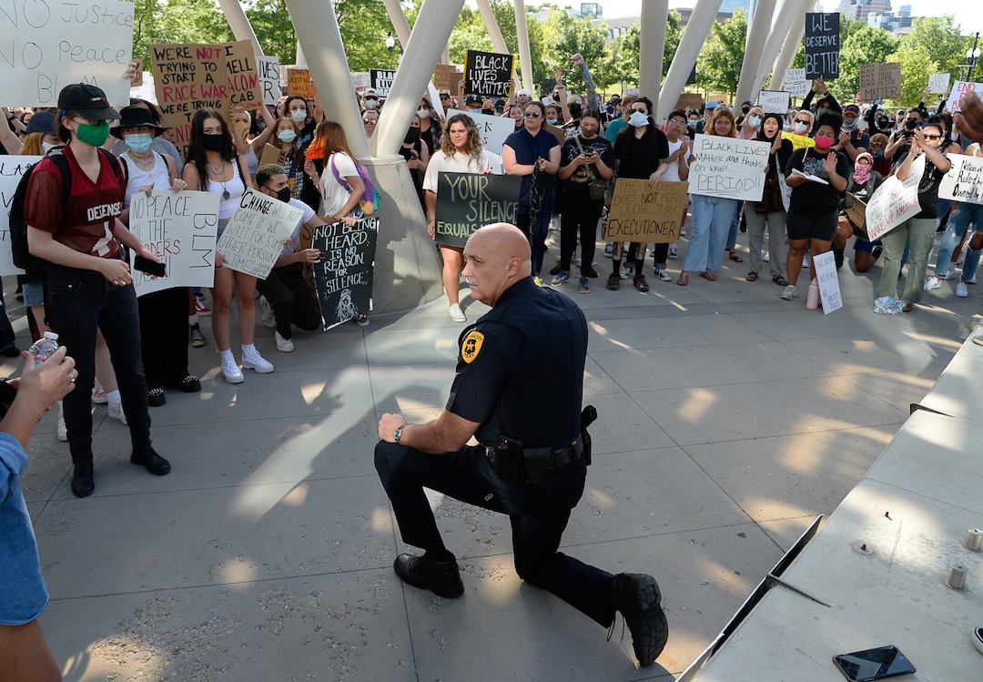 (Francisco Kjolseth  |  The Salt Lake Tribune) Salt Lake City Police Chief Mike Brown takes a knee as he shows his support of demonstrators protesting against police brutality on Wednesday, June 3, 2020, in downtown Salt Lake City, at the Salt Lake City Public Safety Building as the initially set 8 p.m. weeklong curfew was removed.