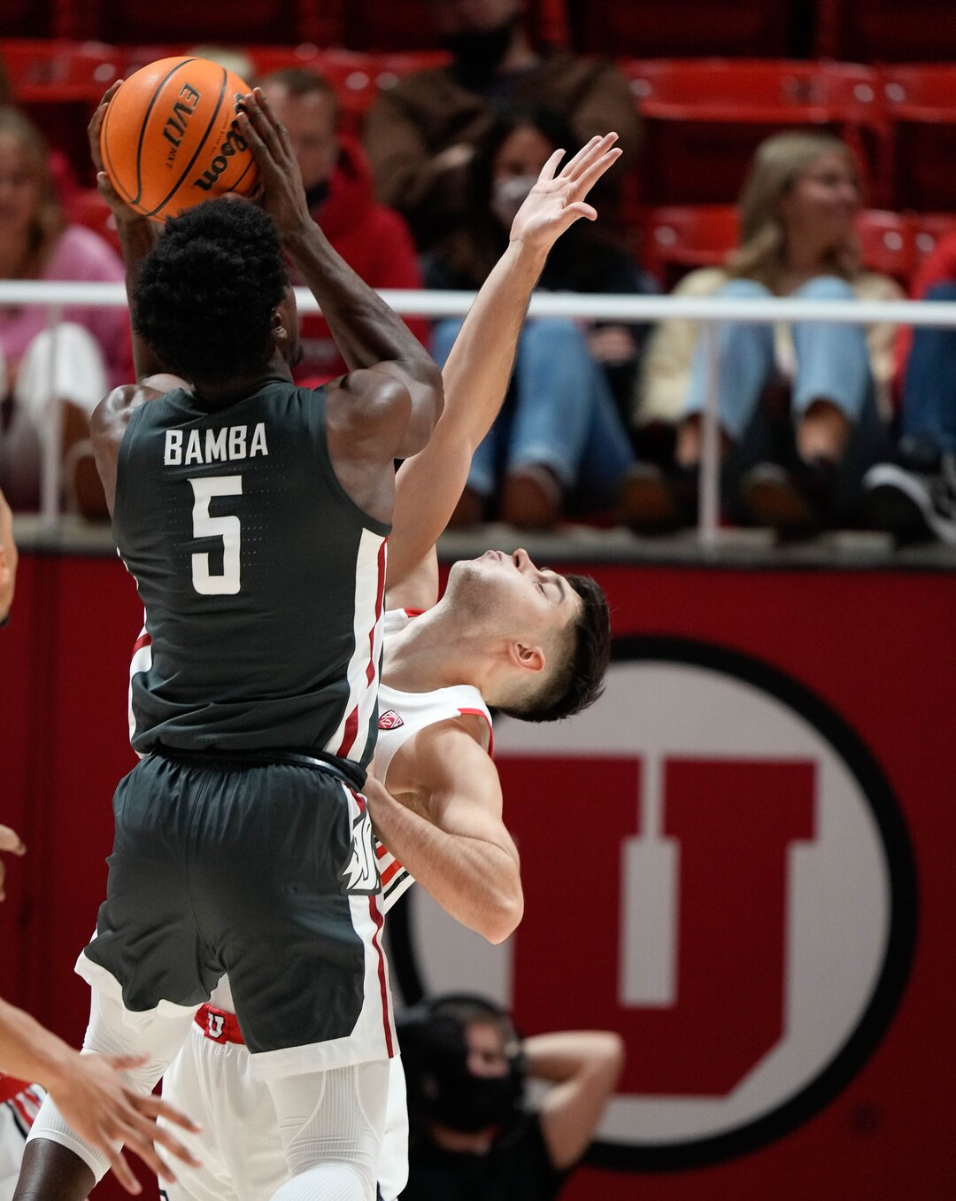 (Francisco Kjolseth | The Salt Lake Tribune) Washington State Cougars guard T.J. Bamba (5) goes over Utah Utes guard Lazar Stefanovic (20) on his way to the basket in game action during an NCAA college basketball game at the Jon M.Huntsman Center, on Saturday, Jan. 8, 2022. Utah lost 61-77.