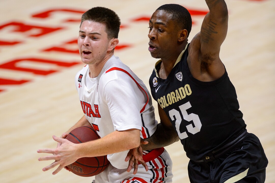(Trent Nelson  |  The Salt Lake Tribune) Utah Utes guard Rylan Jones (15) defended by Colorado Buffaloes guard McKinley Wright IV (25) as Utah hosts Colorado, NCAA basketball in Salt Lake City on Monday, Jan. 11, 2021.