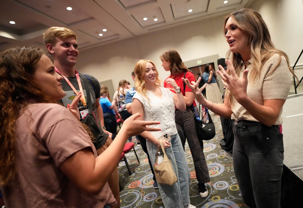 (Francisco Kjolseth | The Salt Lake Tribune) Sydney Coles and Ryan Nisbet, left, speak with Ashly Stone, host of the “Come Back" podcast, after a breakout session during the Together in Christ YSA Conference at the Salt Palace Convention Center on Friday, Aug. 29, 2025.