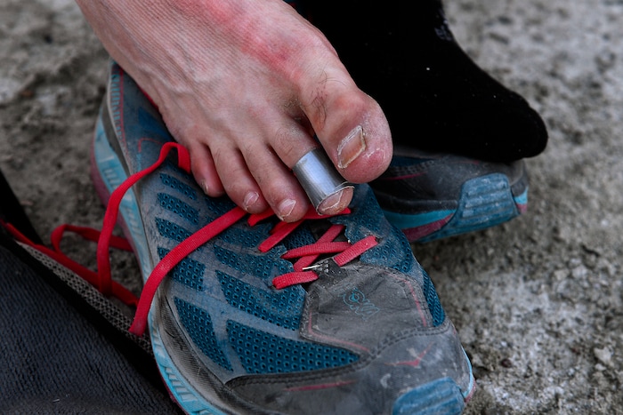 (Scott Sommerdorf | The Salt Lake Tribune)
Alex Doolan changes his socks at the last checkpoint at the Salt Flats 100 Endurance Run, Saturday, May 5, 2018. His toes were bandaged with duct tape.
