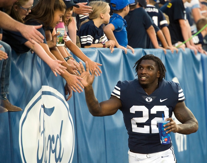 (Rick Egan  |  The Salt Lake Tribune)    Brigham Young Cougars running back Squally Canada (22) high-fives the crowd after the Brigham Young Cougars defeated the McNeese State Cowboys 30-3, at Lavell Edwards Stadium, Saturday, Sept. 22, 2018.


