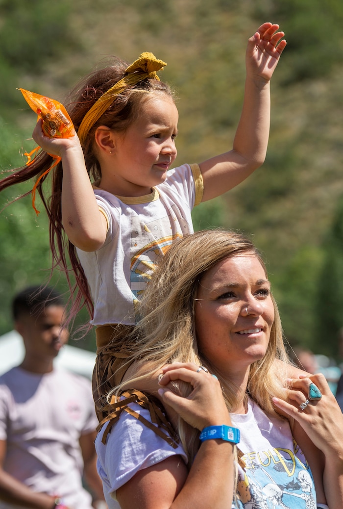 (Rick Egan  |  The Salt Lake Tribune)  Caitlin Kanayan, from Lake Arrow head California, dances with her 4-year-old daughter Trudy on her shoulders, at the Regge Rise Up Music Festival at the Rivers Edge near Heber City, Saturday, Aug. 24, 2019.