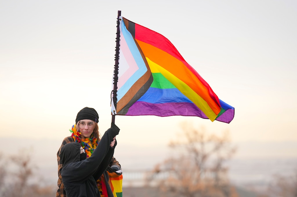 (Bethany Baker  |  The Salt Lake Tribune) An attendee waves a progress pride flag during the Rally for Trans Community Support at the Capitol in Salt Lake City Friday, Jan. 24, 2025.