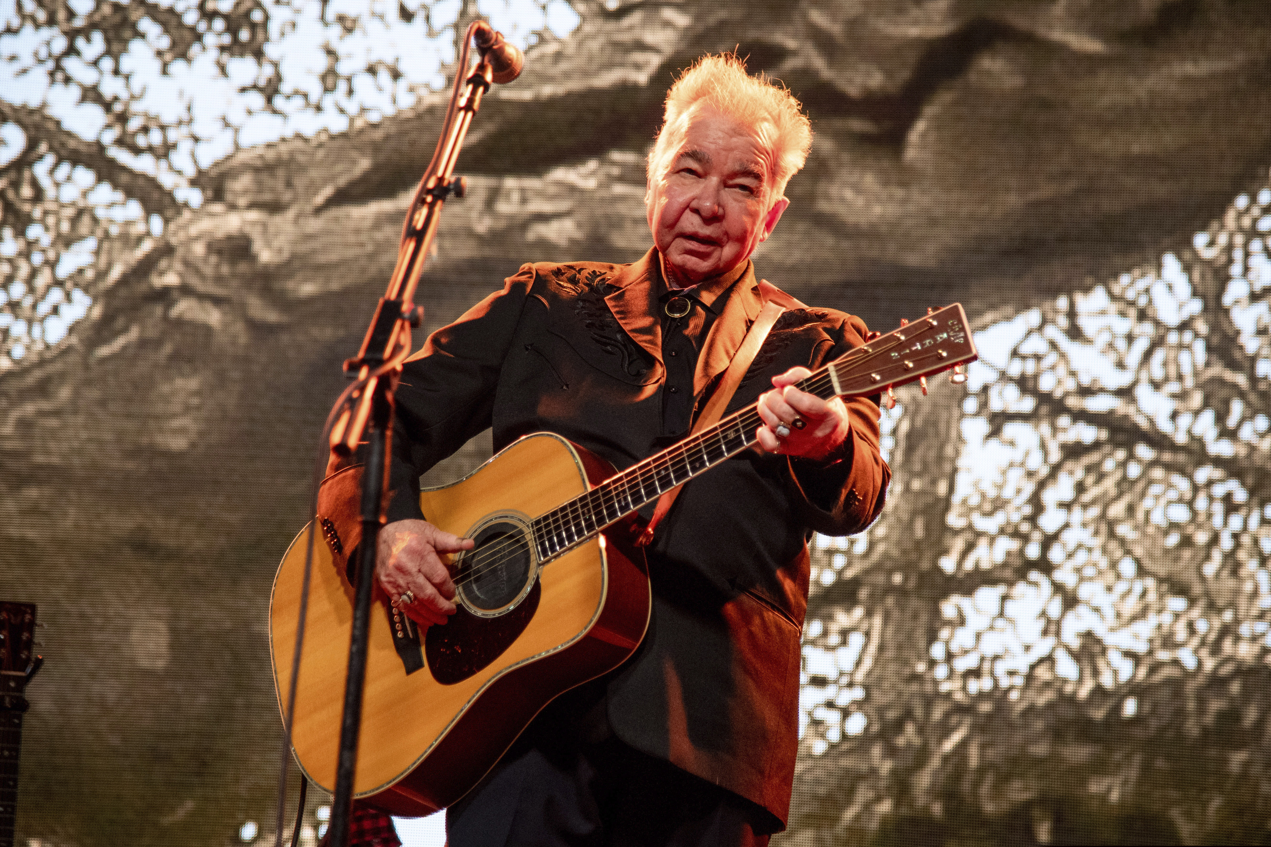 (Photo by Amy Harris/Invision/AP, File) This June 15, 2019 photo shows John Prine performing at the Bonnaroo Music and Arts Festival in Manchester, Tenn. The family of John Prine says the singer-songwriter is critically ill and has been placed on a ventilator while being treated for COVID-19-type symptoms. A message posted on Prine's Twitter page Sunday, March 29, 2020 said the “Angel from Montgomery” singer has been hospitalized since Thursday and his condition worsened on Saturday.