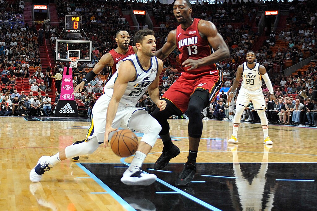 Utah Jazz guard Raul Neto (25) drives to the basket past Bam Adebayo (13) during the first half of an NBA basketball game, Sunday, Dec 2, 2018, in Miami. (AP Photo/Gaston De Cardenas)