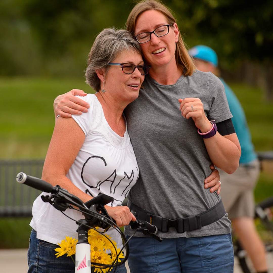 (Trent Nelson | The Salt Lake Tribune)Cyclists gather and ride around Salt Lake City's Liberty Park, Saturday July 21, 2018, in remembrance of Cameron Hooyer, a rider who was killed by a FrontRunner train during a 999 Ride on Thursday. Hooyer's mother Carla, left, is comforted.