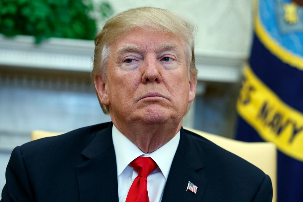 President Donald Trump listens during a meeting with North Korean defectors where he talked with reporters about allowing the release of a secret memo on the FBI's role in the Russia inquiry, in the Oval Office of the White House, Friday, Feb. 2, 2018, in Washington. (AP Photo/Evan Vucci)