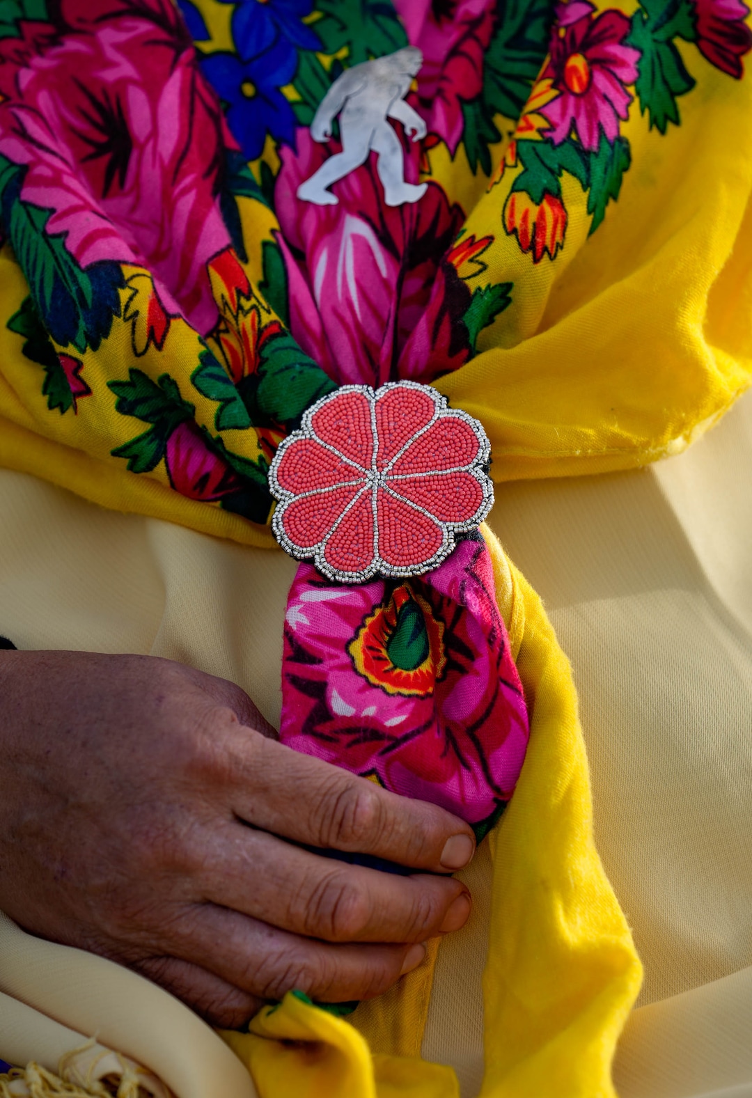 (Francisco Kjolseth | The Salt Lake Tribune) Vicky Yellowhorse talks about the Intricate beadwork of a flower made by her aunt ,as she wears it alongside a pendant of big foot which she loves and finds fun to wear for the start of a Bear Dance in the reservation community of Whiterocks in eastern Utah on Thursday, May 19, 2022.