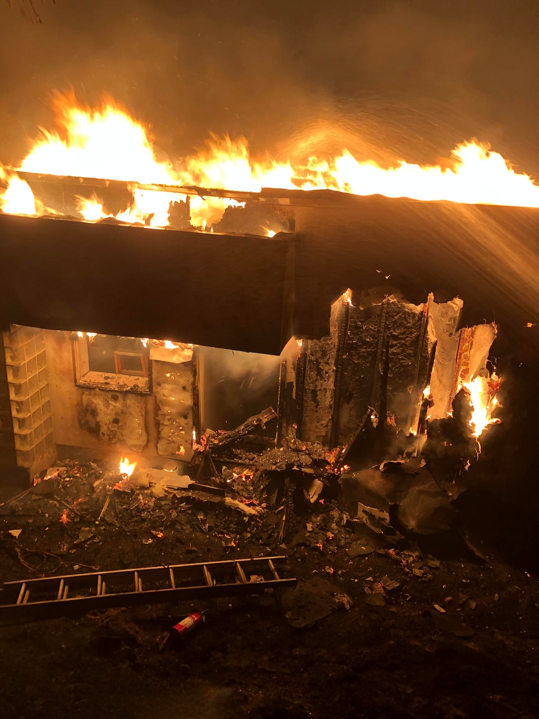 (Photo courtesy of Clair Asay) A wildfire burns through three houses early Friday morning in Bountiful, Aug. 30, 2019. On Sept. 2, officials said the fire was 100% contained.