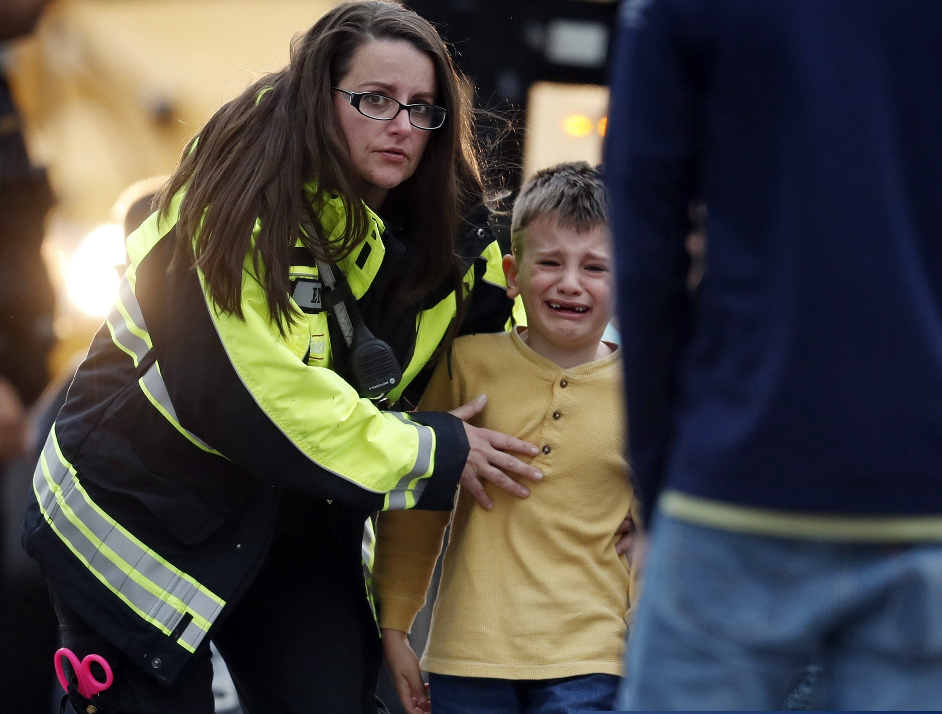 (AP Photo/David Zalubowski) Officials guide students off a bus and into a recreation center where they were reunited with their parents after a shooting at a suburban Denver middle school Tuesday, May 7, 2019, in Highlands Ranch, Colo.