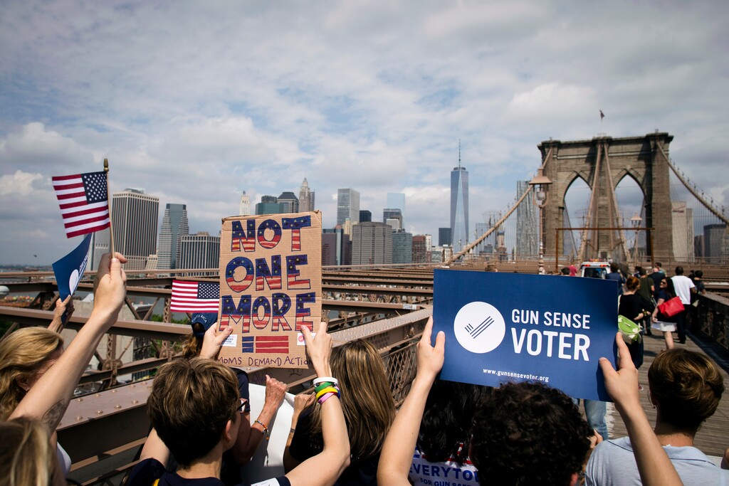 (John Minchillo | AP file photo) This photo from Saturday, June 14, 2014, in New York, shows anti-gun demonstrators — underwritten by former New York Mayor Michael Bloomberg, with signs calling for tougher gun control laws as they march across the Brooklyn Bridge in New York. Bloomberg co-founded Mayors Against Illegal Guns — now part of his Everytown for Gun Safety advocacy group, and has given millions of dollars to pro-gun control candidates.