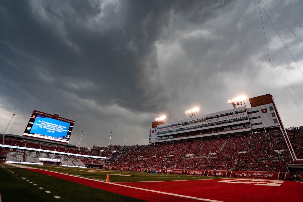 (Francisco Kjolseth | The Salt Lake Tribune) A severe thunder storm brings pouring rain forcing fans out of the stands at the start of the PAC-12 football game between the University of Utah and Weber State at Rice-Eccles Stadium on Thursday, Sept. 2, 2021.