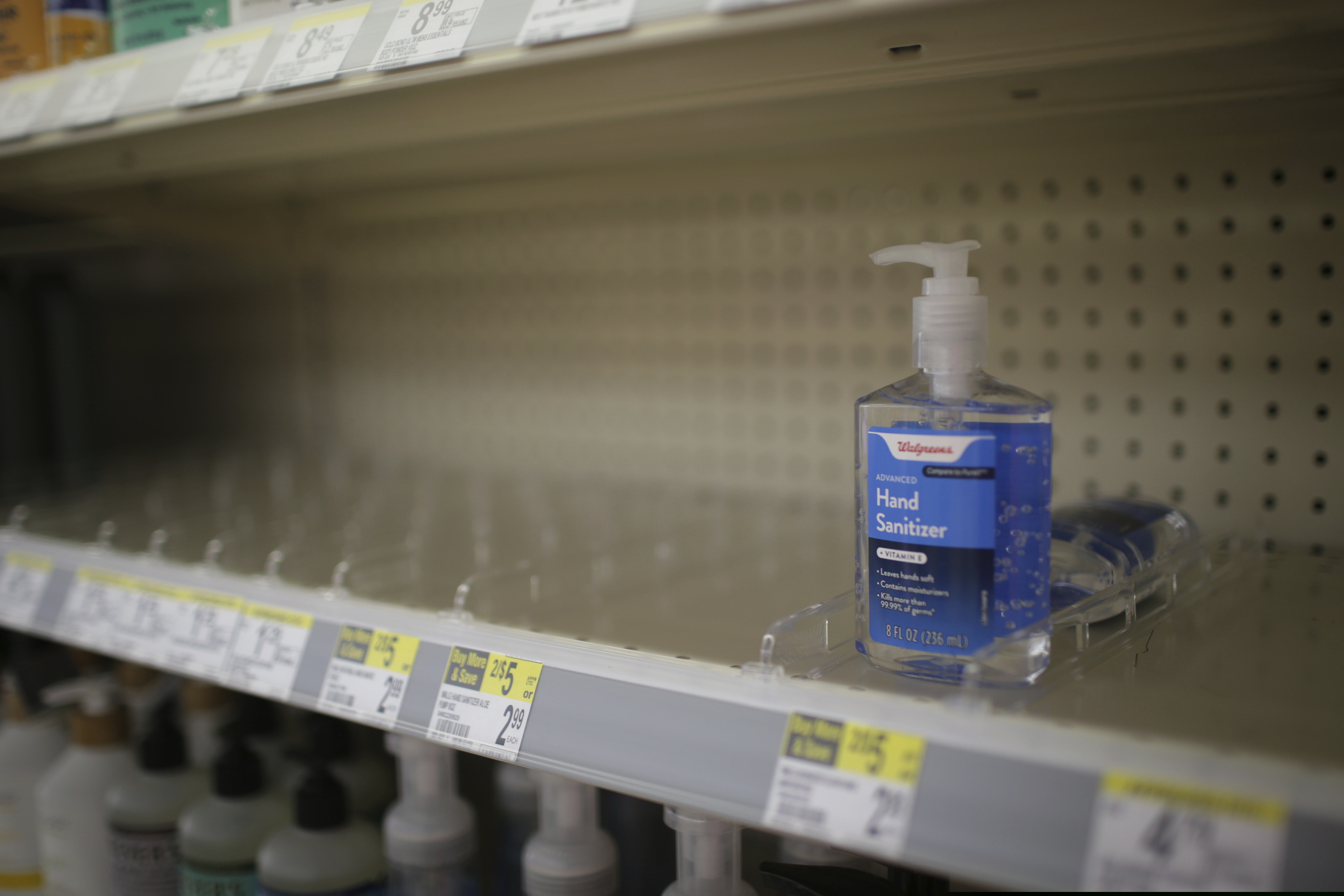 (John Roark | The Idaho Post-Register via AP) In this Feb. 28, 2020 file photo, rows of hand sanitizer are seen empty at a Walgreens in Idaho Falls, Idaho. Fear of the coronavirus has led people to stock up on hand sanitizer, leaving store shelves empty and online retailers with sky-high prices set by those trying to profit on the rush.