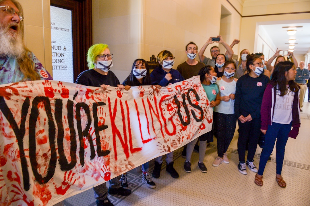 (Leah Hogsten  |  The Salt Lake Tribune) Opponents of the proposed inland port are escorted out of the Utah Inland Port Authority Board meeting by Utah Highway Patrol officers at the Capitol, June 5, 2019. The Inland Port Authority Board had to cancel its meeting last month after a group of protesters took over the meeting.