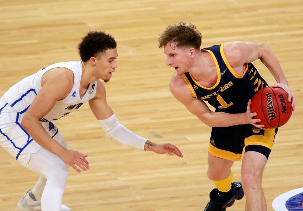 UC Irvine's Dawson Baker keeps the ball from UC Santa Barbara's Jaquori McLaughlin (3) during the first half of an NCAA college basketball game for the championship of the Big West Conference men's tournament Saturday, March 13, 2021, in Las Vegas. (AP Photo/Ronda Churchill)