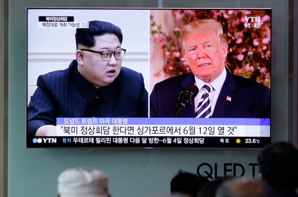 People watch a TV screen showing file footage of U.S. President Donald Trump, right, and North Korean leader Kim Jong Un during a news program at the Seoul Railway Station in Seoul, South Korea, Saturday, May 26, 2018. South Korea on Saturday expressed cautious relief about the revived talks for a summit between President Donald Trump and North Korean leader Kim Jong Un following a whirlwind 24 hours that saw Trump canceling the highly-anticipated meeting before saying it's potentially back on. The letters read "if the summit does happen, will likely take place on June 12 in Singapore." (AP Photo/Lee Jin-man)