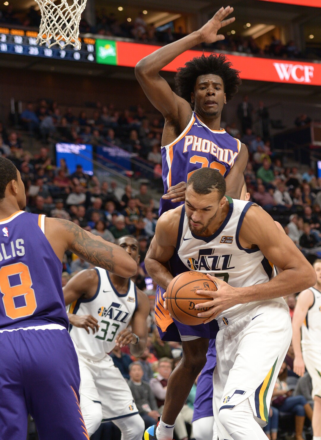 (Leah Hogsten  |  The Salt Lake Tribune)  Utah Jazz center Rudy Gobert (27) is fouled under the net by Phoenix Suns forward Anthony Bennett (23) as the Utah Jazz host the Phoenix Suns during preseason NBA basketball at Vivint Smart Home Arena in Salt Lake City, October 6, 2017.