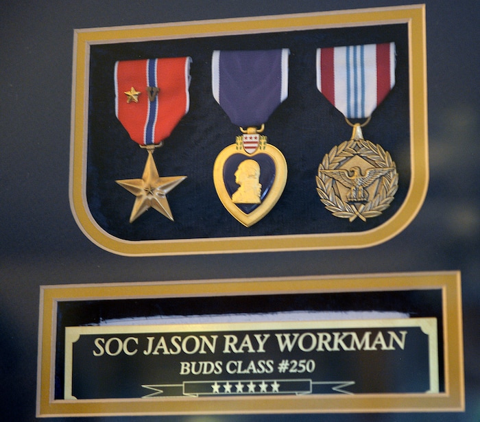 Al Hartmann  |  The Salt Lake Tribune 
Jason Workman's double Bronze Star, Purple Heart and Presidential medal at his parents' Betty and Rodney Workman home in Blanding.  Jason Workman, a member of Seal Team 6 was among 38 military personnel shot down by Taliban fighters in a Chinook helicopter on Aug. 6, 2011. It was the largest loss of U.S. life in the Afghanistan campaign.  Two Utahns were on the helicopter,  Taylorsville's Jared Day and Blanding's Jason Workman. Five years later, family and friends still grapple with their absence while battling to keep alive their memory — Workman, as a big, daring family man with a kind heart and Day as a "goofball" who loved video games and anime and who could make people laugh during times of extreme stress.
The two men shared a birthday, Aug. 12.  