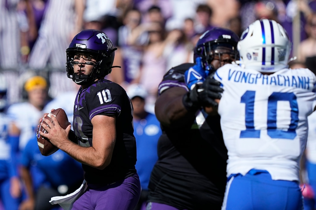 (LM Otero | AP) TCU quarterback Josh Hoover (10) looks to pass with blocking against BYU linebacker AJ Vongphachanh (10) during the first half of an NCAA college football game Saturday in Fort Worth, Texas.