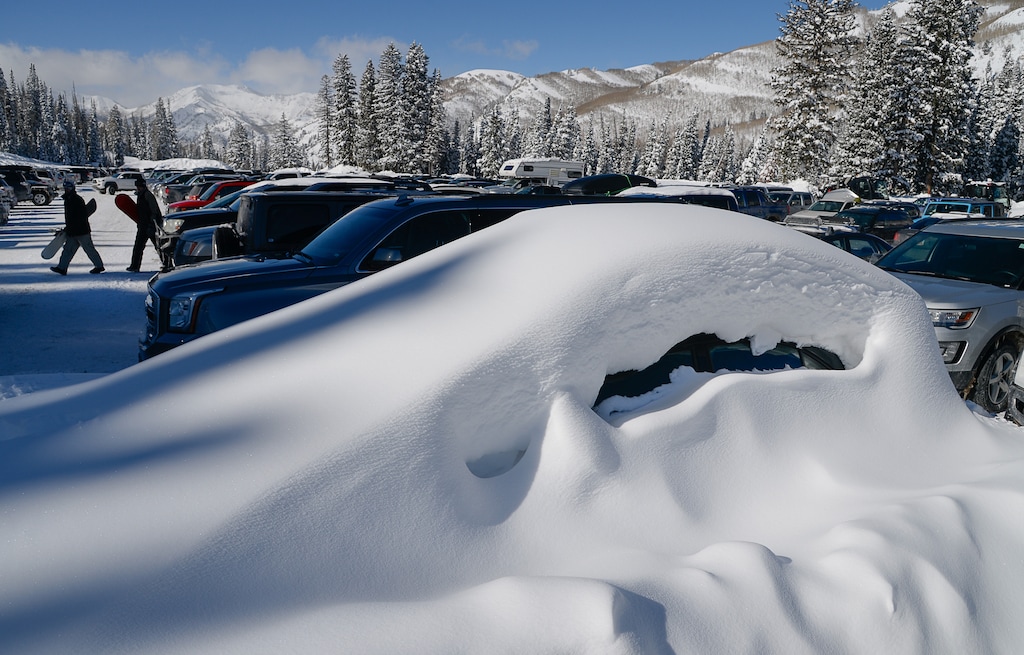 (Francisco Kjolseth  |  The Salt Lake Tribune)  A buried car reveals the snow accumulations in the high country as people enjoy a bluebird day at Solitude Mountain Resort on Thursday, Feb. 7, 2019.