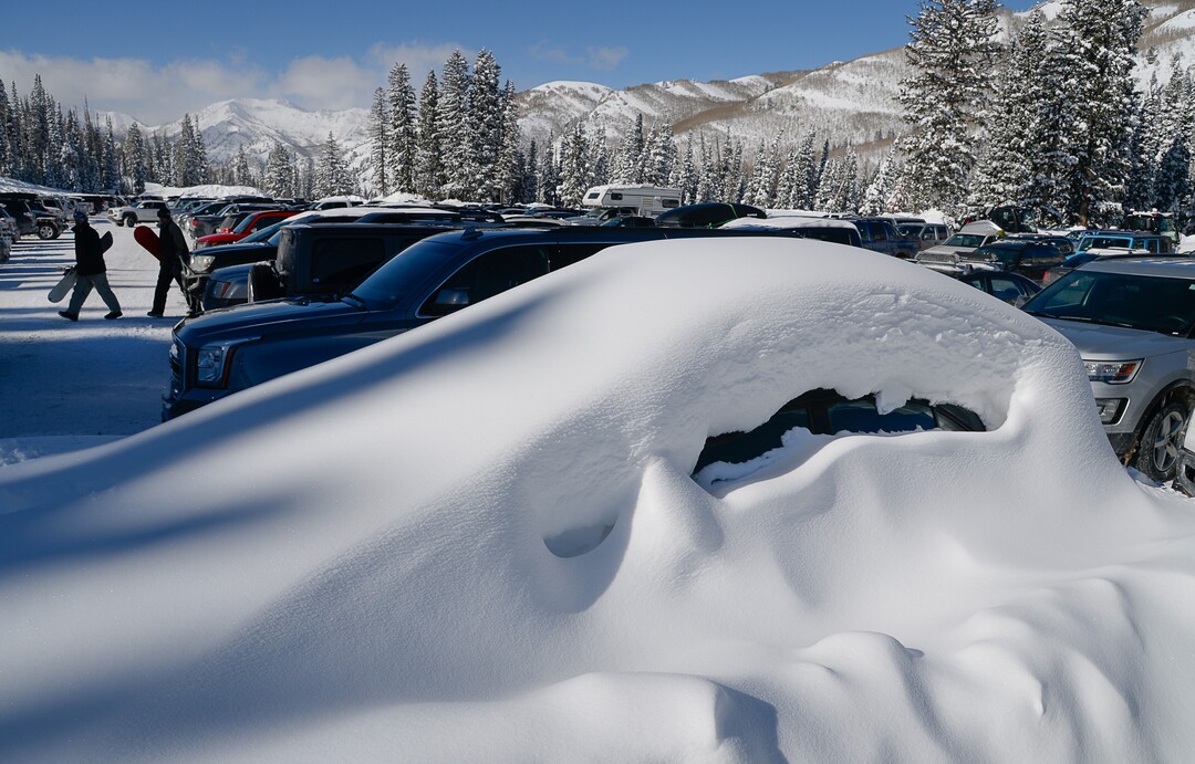 (Francisco Kjolseth  |  The Salt Lake Tribune)  A buried car reveals the snow accumulations in the high country as people enjoy a blue bird day at Solitude Mountain Resort on Thursday, Feb. 7, 2019.