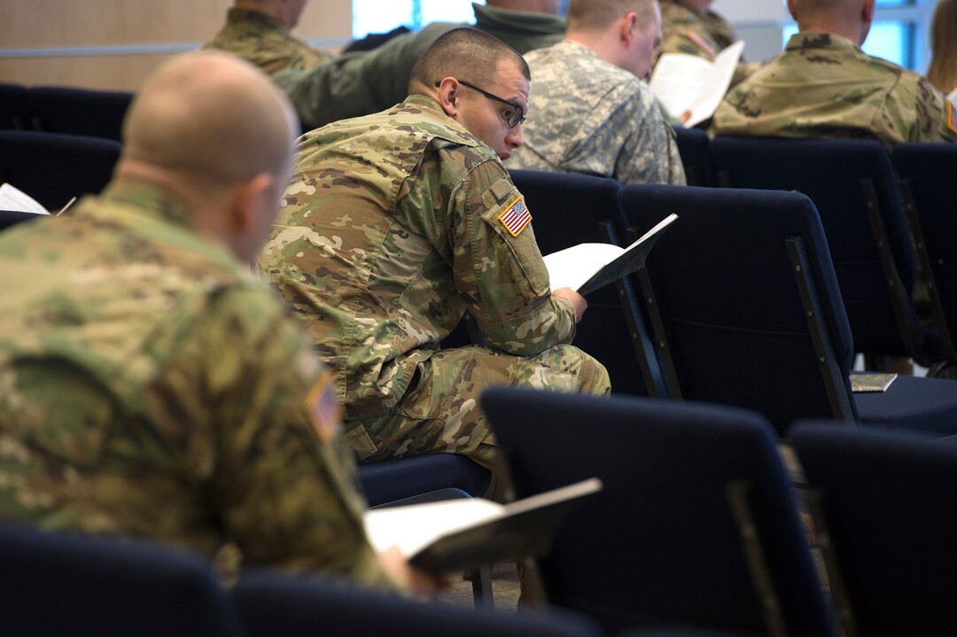 Scott Sommerdorf | The Salt Lake TribuneServicemen follow along in the hymnal during an LDS service at the Camp Williams chapel, Sunday, March 4, 2018.