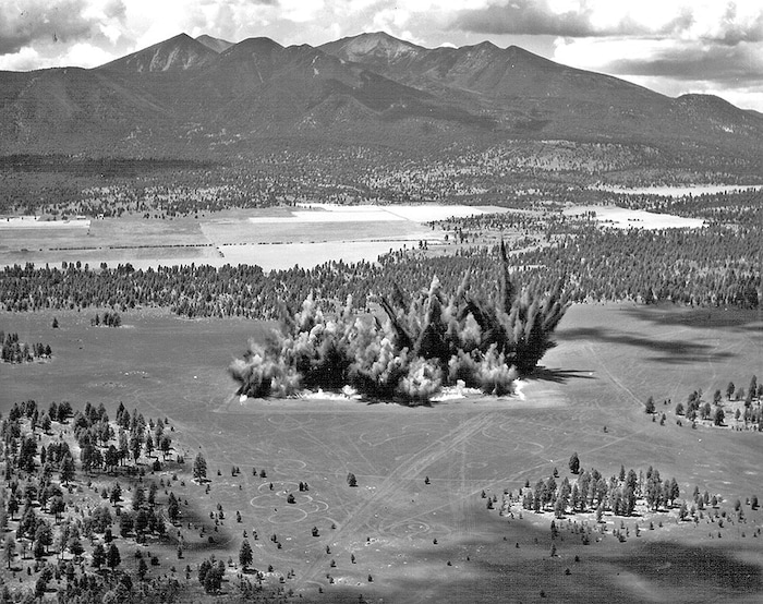 (U.S. Geological Survey Astrogeology Science Center via AP) This 1968 photo provided by the U.S. Geological Survey Astrogeology Science Center shows craters being created in a volcanic cinder field east of Flagstaff, Ariz. Astronauts who walked on the moon used the site for training.