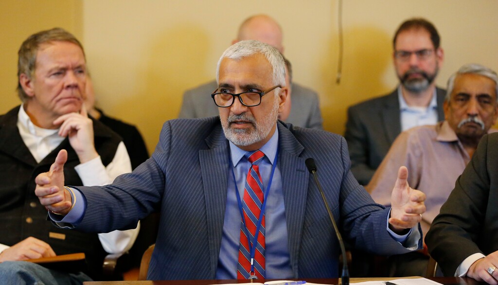 Salt Lake County District Attorney Sim Gill speaks to the members of the Senate Judiciary, Law Enforcement, and Criminal Justice Standing Committee at the Utah State Capitol, Thursday, Feb. 21, 2019, in Salt Lake City. A panel of lawmakers is approving a proposal to strengthen Utah's hate-crimes law, a key step forward for the idea long stuck in legislative gridlock. (AP Photo/Rick Bowmer)