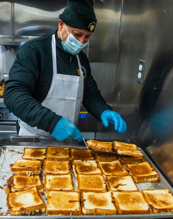 (Rick Egan | The Salt Lake Tribune)  Mike Youseff makes grilled cheese sandwiches for 600 health care workers as part of the the Curds + Kindness program, which supports local dairy farmers, at the South Jordan Health Center in Daybreak on Tuesday, Dec. 1, 2020.