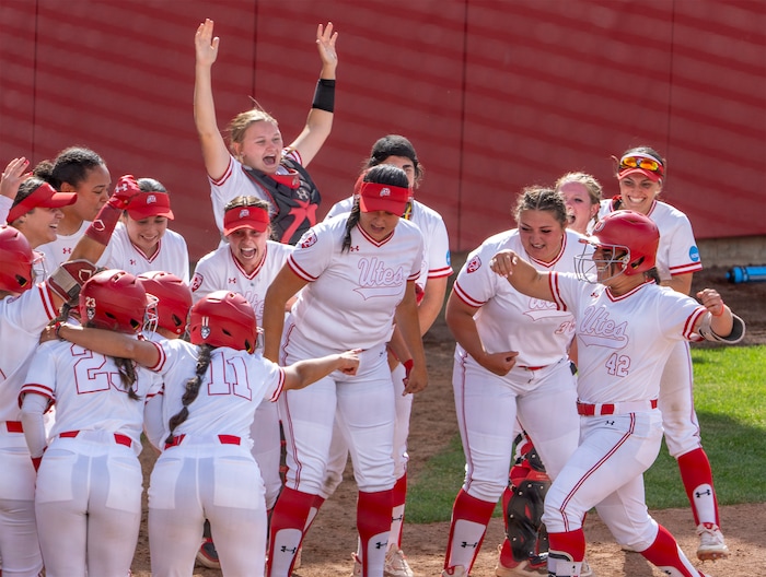 (Rick Egan | The Salt Lake Tribune)  Team mates wait for Julia Jimenez to cross home plate, after hitting a grand slam home run, giving Utah a 7-1 lead, in NCAA Softball Super Regionals action between the Utah Utes and the San Diego State Aztecs, on Saturday, May 27, 2023.

