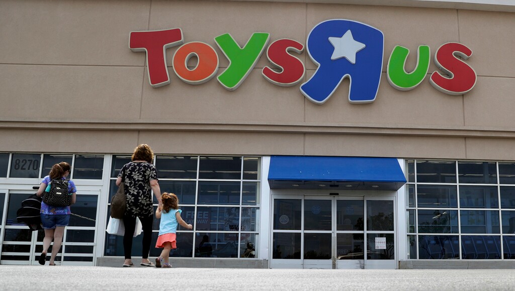 FILE - In this Sept. 19, 2017, file photo, shoppers walk into a Toys R Us store, in San Antonio. Toys R Us says it will be closing some U.S. stores and converting others to cobranded locations as it continues to deal with its financial restructuring following its bankruptcy filing. (AP Photo/Eric Gay, File)