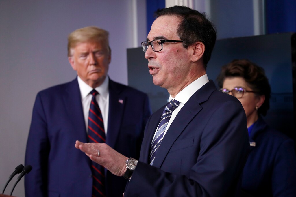 (Alex Brandon | AP) In this April 2, 2020 photo, President Donald Trump and Jovita Carranza, administrator of the Small Business Administration, listen as Treasury Secretary Steven Mnuchin speaks about the coronavirus in the James Brady Press Briefing Room of the White House in Washington. Hundreds of cities and counties grappling with the economic fallout caused by the pandemic might receive little, if any, of the emergency funding allotted for state and local governments in the $2.2 trillion coronavirus stimulus package.