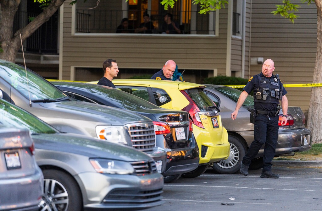(Rick Egan | The Salt Lake Tribune) Salt Lake City Police look through car windows as they investigate a shooting at the Pebble Creek Apartments on 1700 South, where on person was killed and three were injured, on Monday, June 6, 2022.
