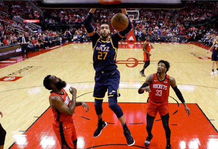 Utah Jazz center Rudy Gobert (27) dunks as Houston Rockets guard James Harden, left, forward Robert Covington (33) watch during the first half of an NBA basketball game, Sunday, Feb. 9, 2020, in Houston. (AP Photo/Eric Christian Smith)