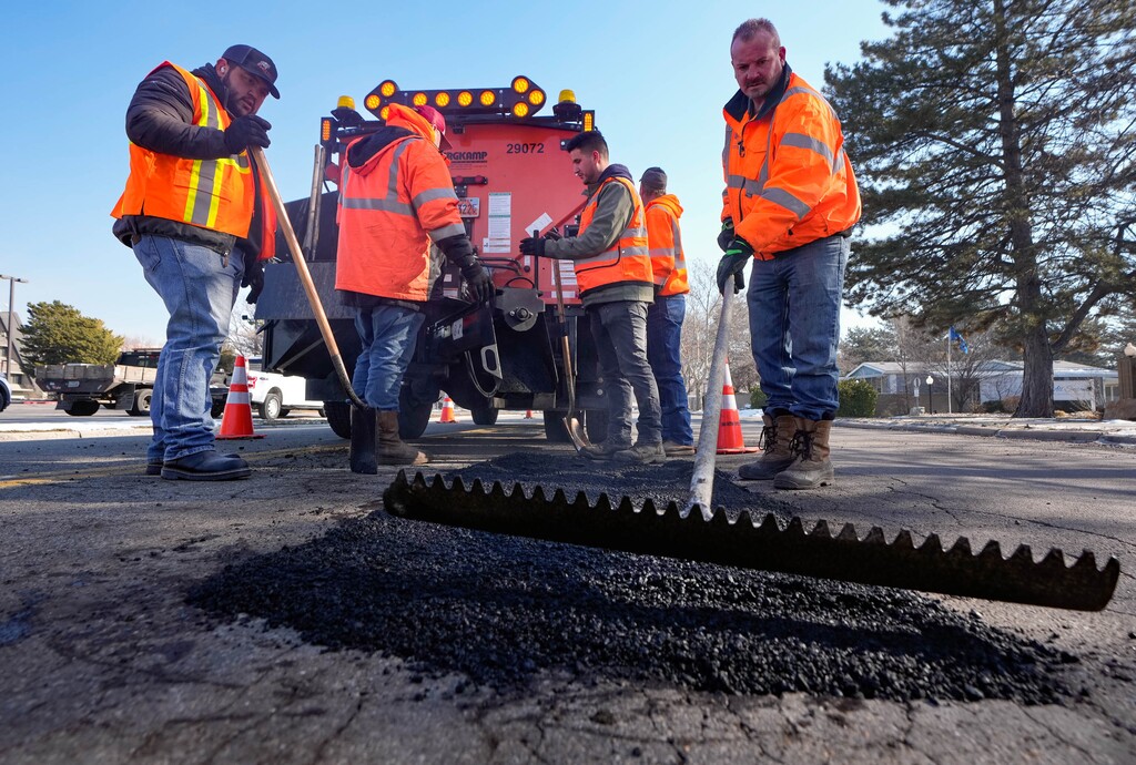 (Francisco Kjolseth | The Salt Lake Tribune)  Salt Lake City crews fill potholes along North Star Drive near Redwood Road on Wednesday, Feb. 1, 2023.